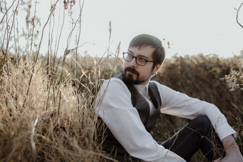 An image of Cody, as seen sitting in a field.